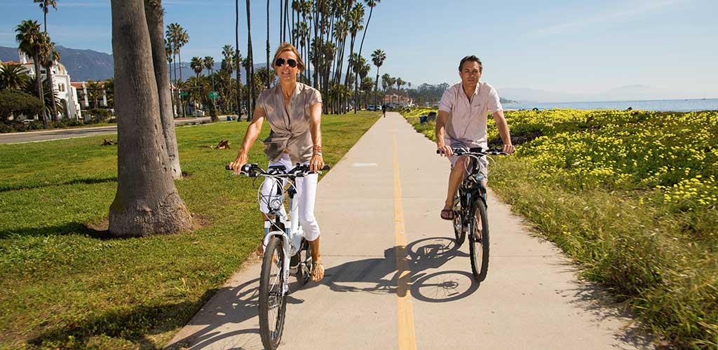 Two people riding bikes on a trail